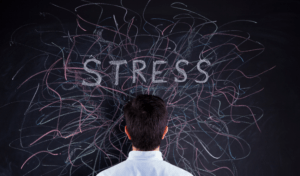 man looking at full chalk board stressed